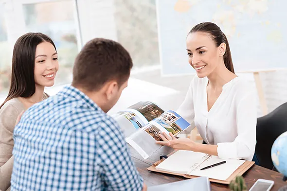 Tour agent guiding a couple on an affordable and informative tour of local attractions.