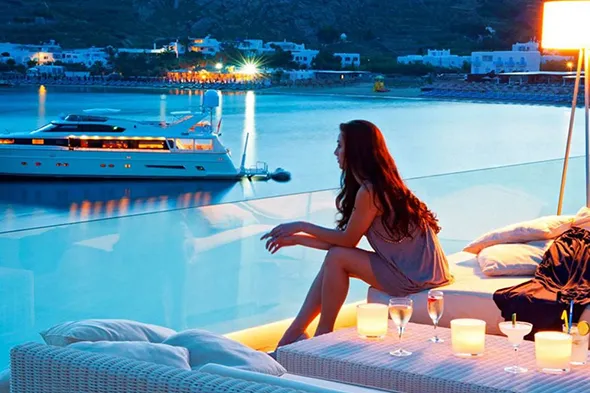 The girl is enjoying the magnificent view of the evening sea from the cruise ship.